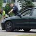 Ann Arbor police officers investigate a vehicle at the scene where a pedestrian was struck by a car while attempting to cross Plymouth Rd. between Traverwood Dr. and Nixon Rd. on Wednesday, August 7, 2013. Melanie Maxwell | AnnArbor.com 